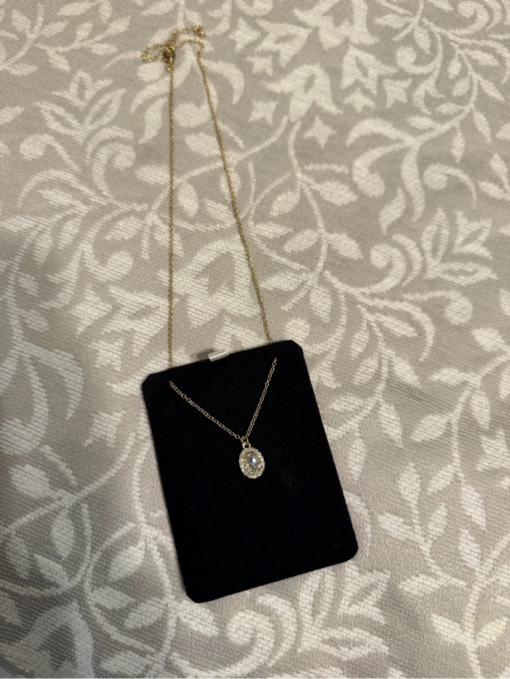 Delicate Gold Oval Halo Necklace with Clear Center Stone